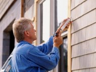 A Go-Glass contractor repairing a window in Dover, DE.