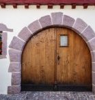 Large double front door with arch bordered with brick